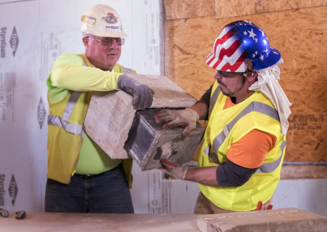 Duane Waite (left) and Greg Johnson, from JC Orr Contractors, pry a time capsule from 1949 out of it’s concrete enclosure. Waite and Johnson found the time capsule hidden in a wall while working on renovations at Penn State’s Willard Building. (Photo by Patrick Mansell)