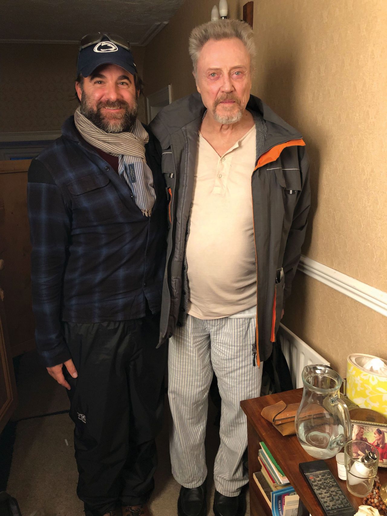 Alumnus Brad Gallow wearing a Penn State hat, poses with actor Christopher Walken