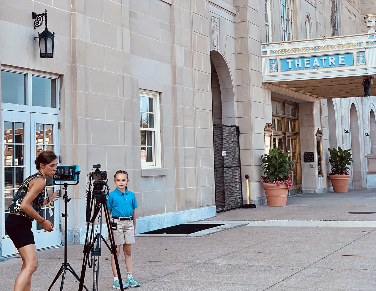 Jessica Paholsky with student outside theatre