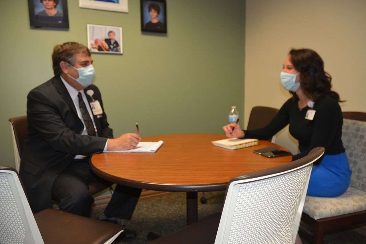 Two people meet in an office