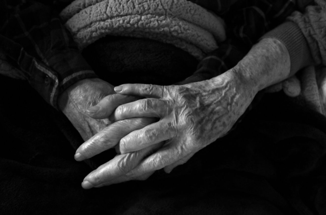Close up photo of two people holding hands