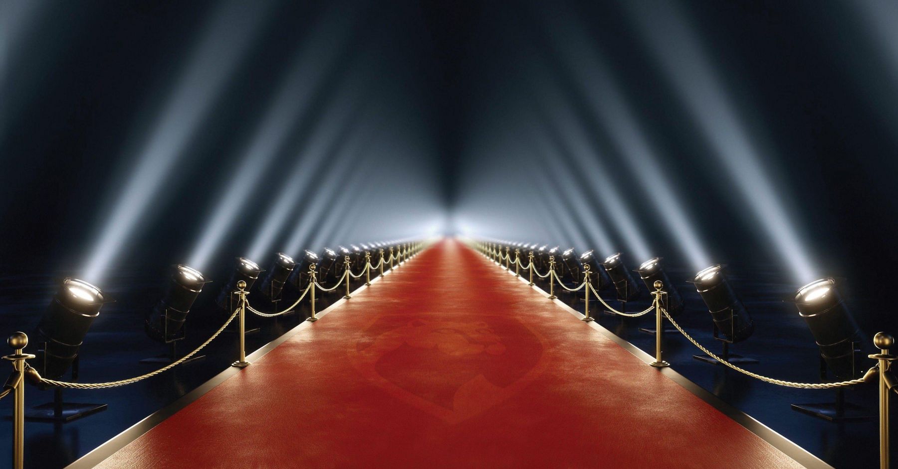 Red carpet walk with gold rope line and moody lighting