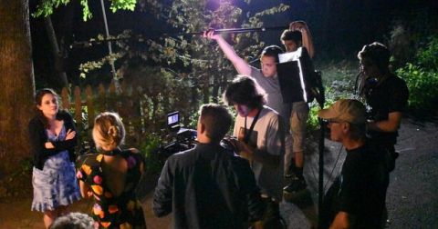 Maura Shea and Rod Bingaman with a camera crew and sound people shooting a film on location at night with lights
